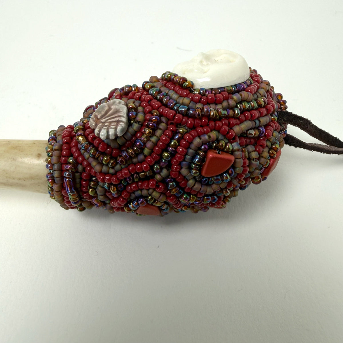 10. Carved Bone Face Talisman