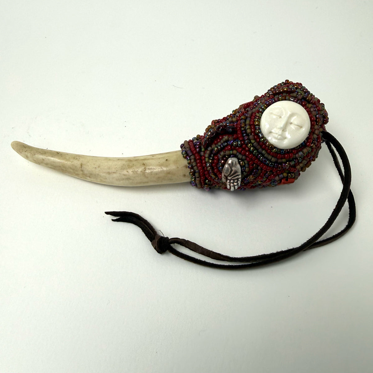 10. Carved Bone Face Talisman