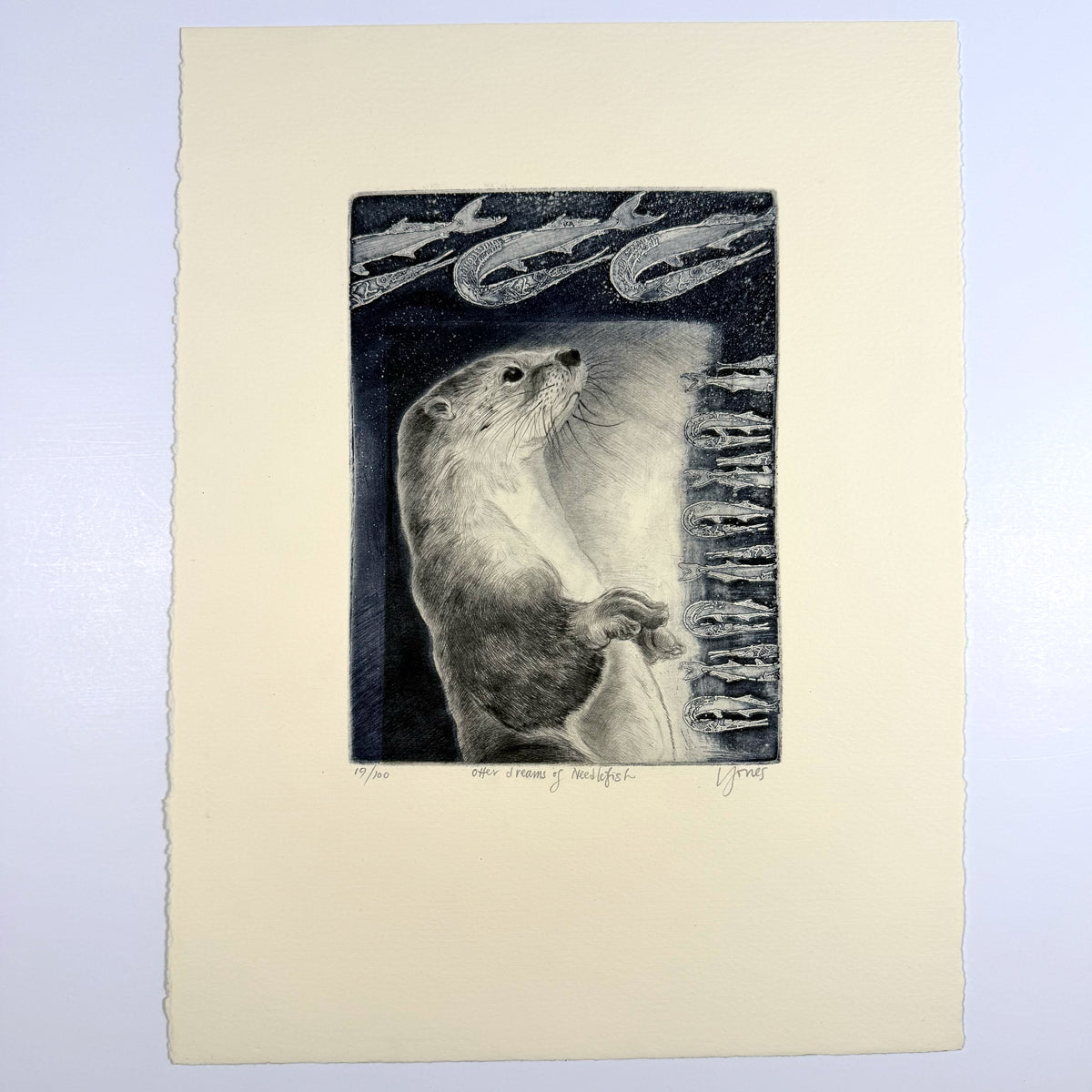 Otter Dreams of Needlefish by Liza Jones, a black-and-white drypoint etching of an otter surrounded by needlefish.