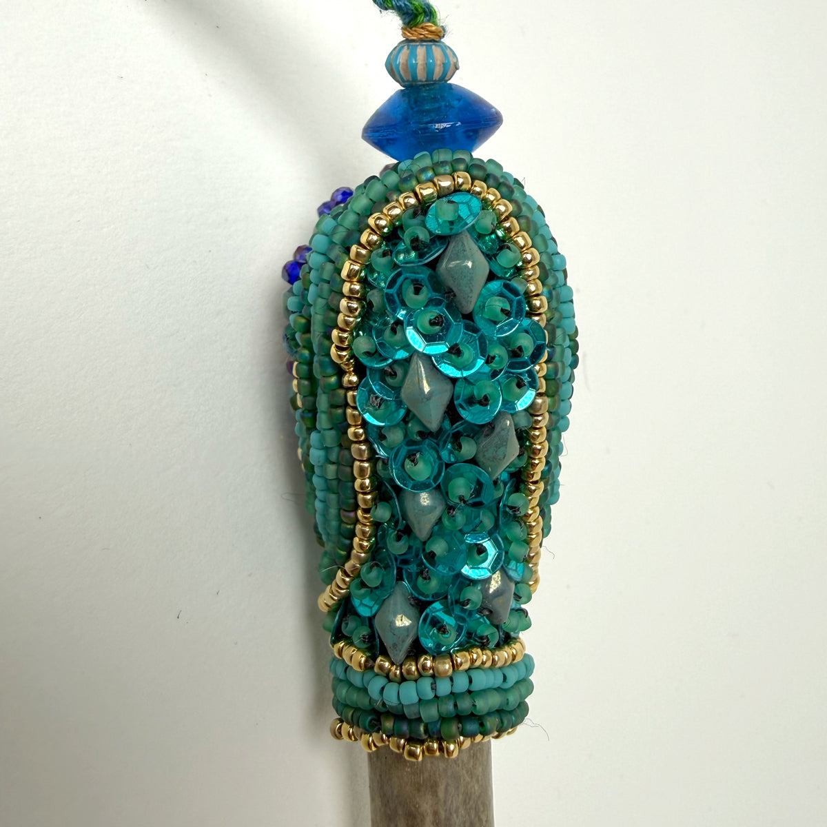 9. Turquoise w/ Sun Face Talisman