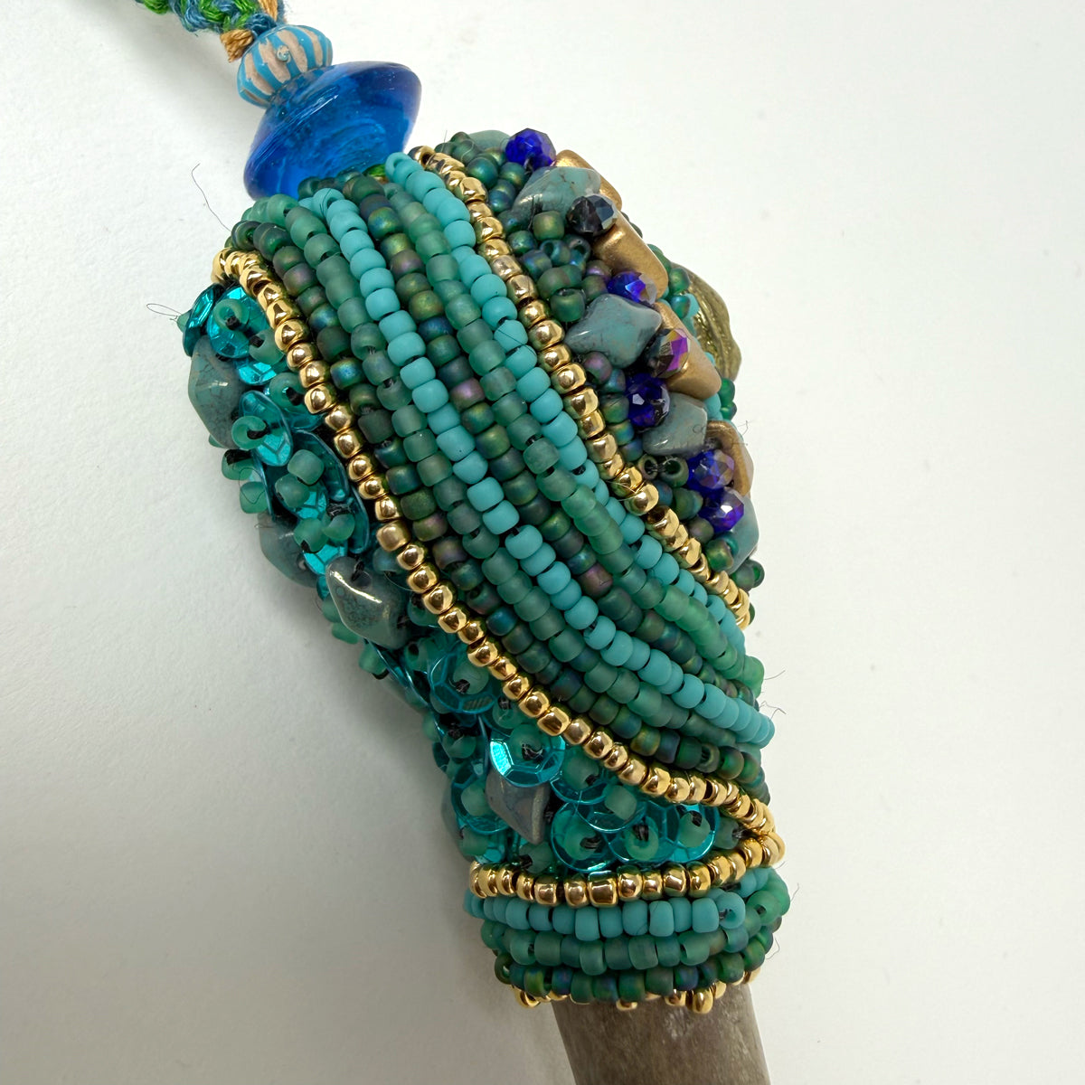 9. Turquoise w/ Sun Face Talisman